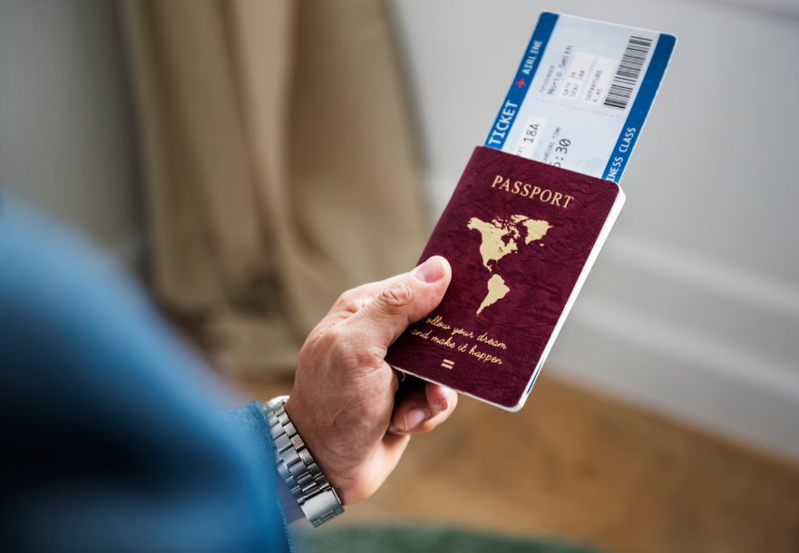 Traveler holding a passport and airline boarding pass