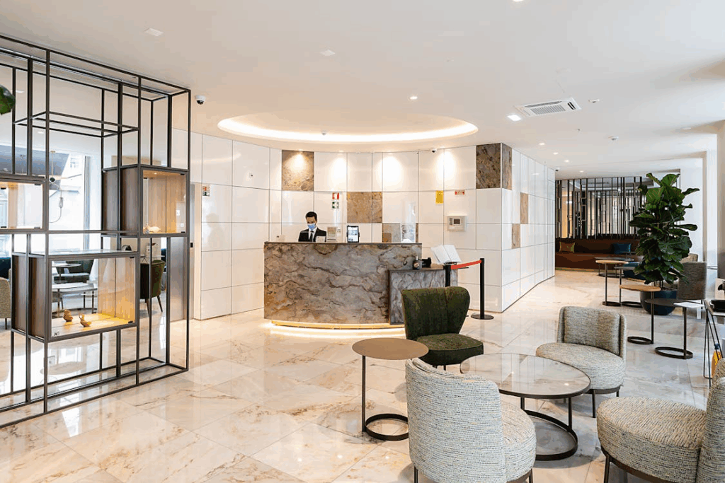 Modern hotel lobby in Portugal with marble floors, contemporary furniture, and a front desk concierge