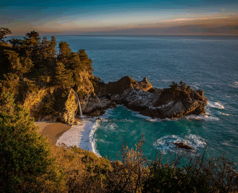 Scenic view of McWay Falls cascading onto a secluded beach in Big Sur