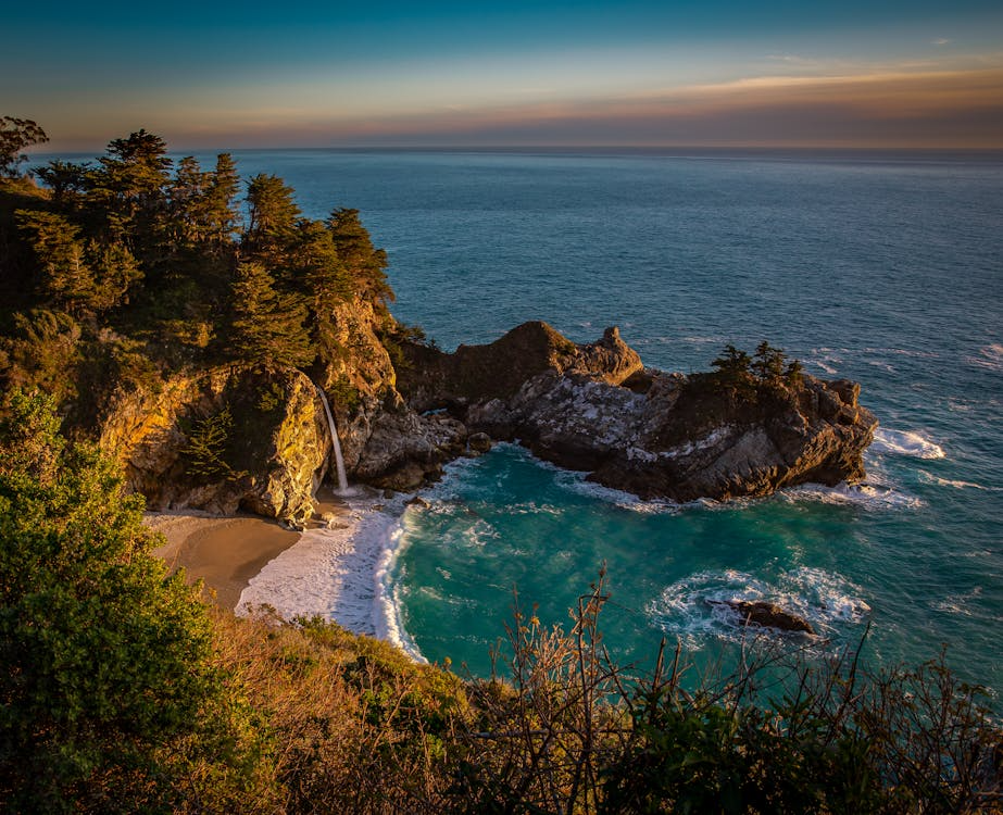 Scenic view of McWay Falls cascading onto a secluded beach in Big Sur