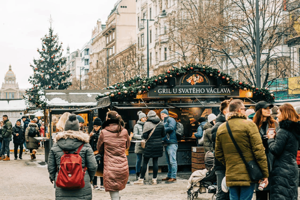 Visitors explore the festive stalls at the Prague Christmas market in Wenceslas Square