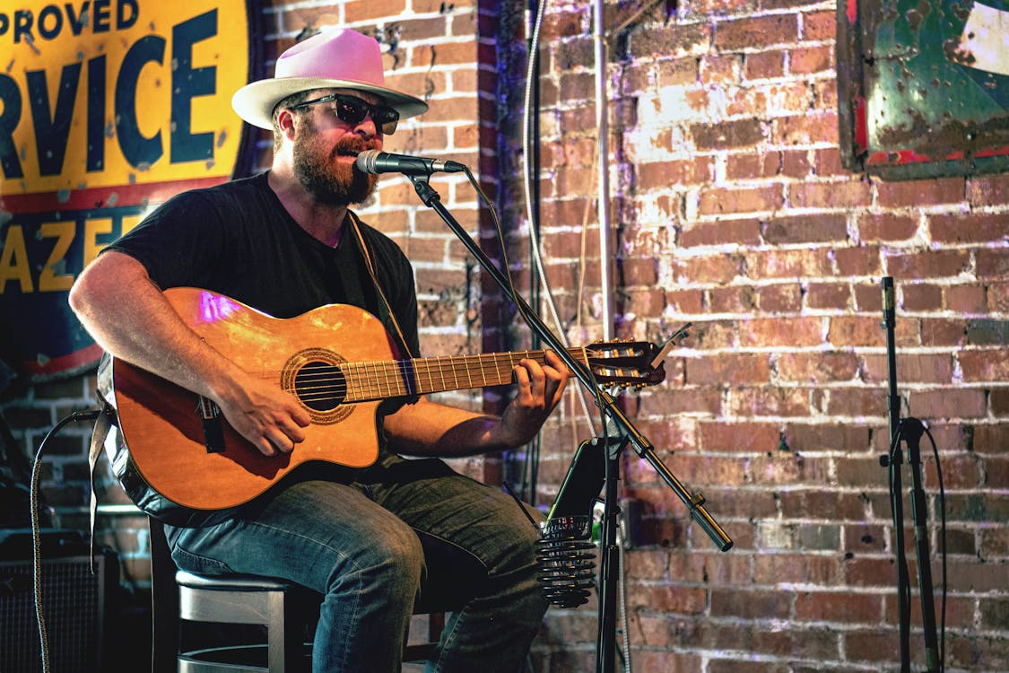 Musician performing live in a Nashville honky-tonk bar, capturing the heart of the Nashville country music scene.