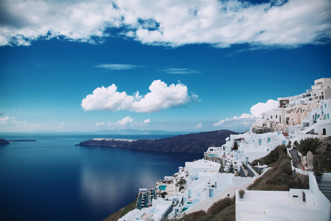 Whitewashed buildings overlooking the Aegean Sea in Santorini during shoulder season travel in Greece