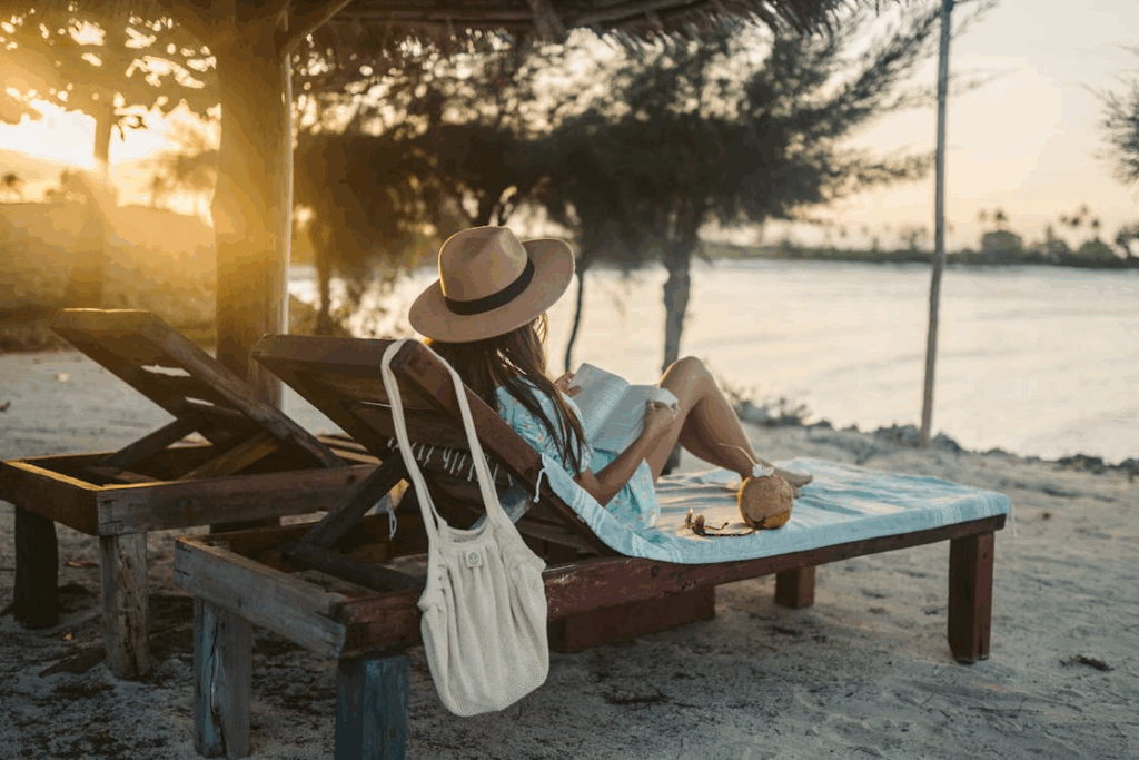 Woman relaxing at an affordable all-inclusive beach resort in Zanzibar, Tanzania during sunset