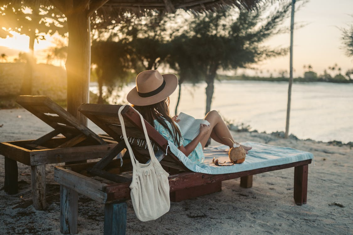 Woman relaxing at an affordable all-inclusive beach resort in Zanzibar, Tanzania during sunset
