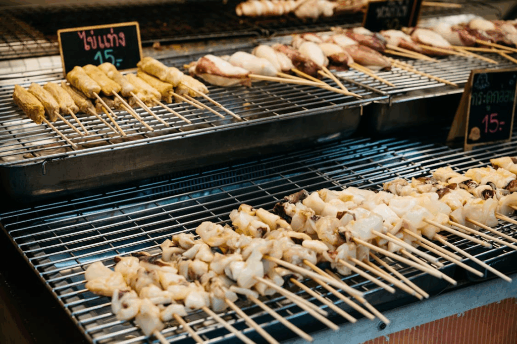 Grilled meat and seafood skewers at a street food market in Bangkok, Thailand