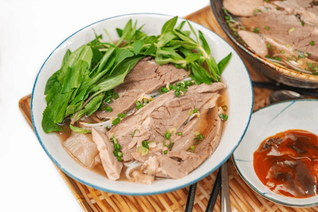 Traditional Vietnamese pho with sliced beef, fresh herbs, and rice noodles in Hanoi