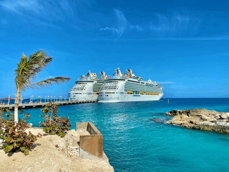 Cruise ships docked at a Caribbean port with turquoise water and clear skies
