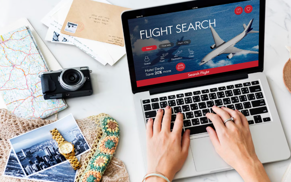 Traveler researching the best day to book flights on a laptop.