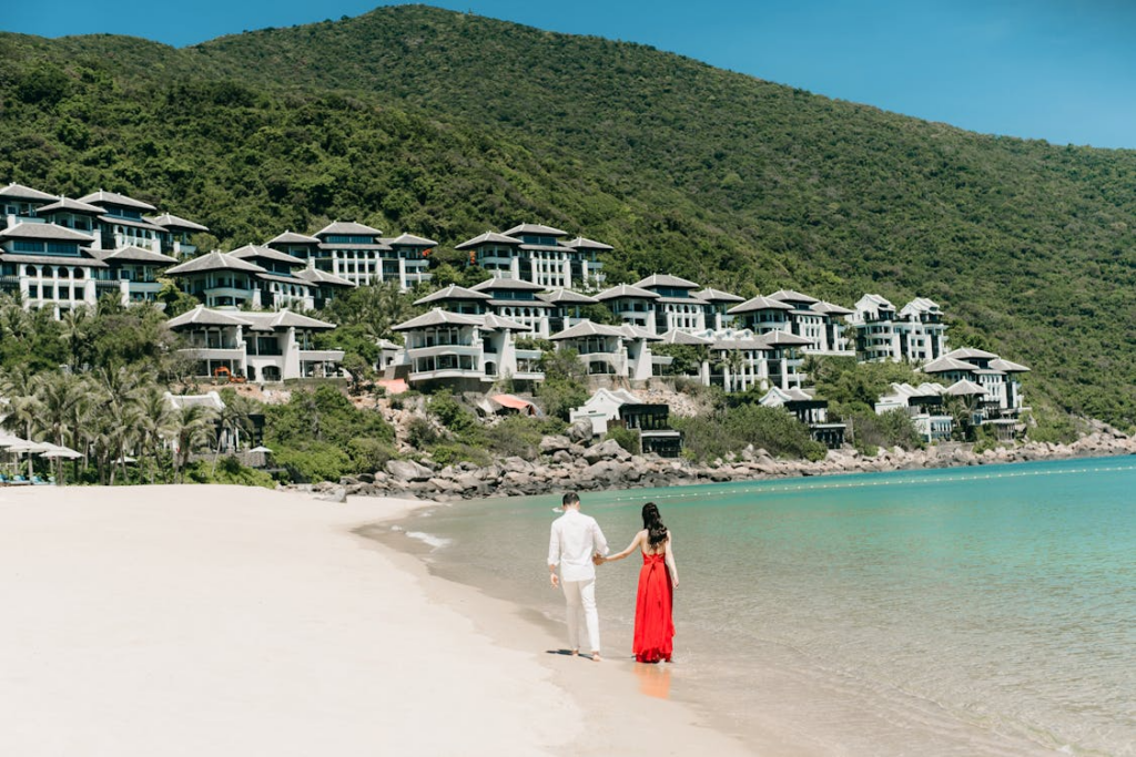 Couple walking along an all-inclusive resort beach.