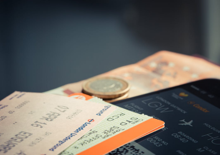 Boarding pass and travel money illustrating hidden airline fees before a flight.