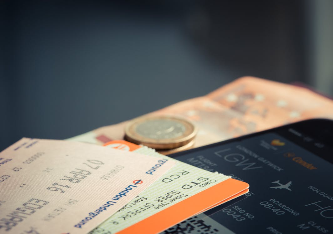 Boarding pass and travel money illustrating hidden airline fees before a flight.
