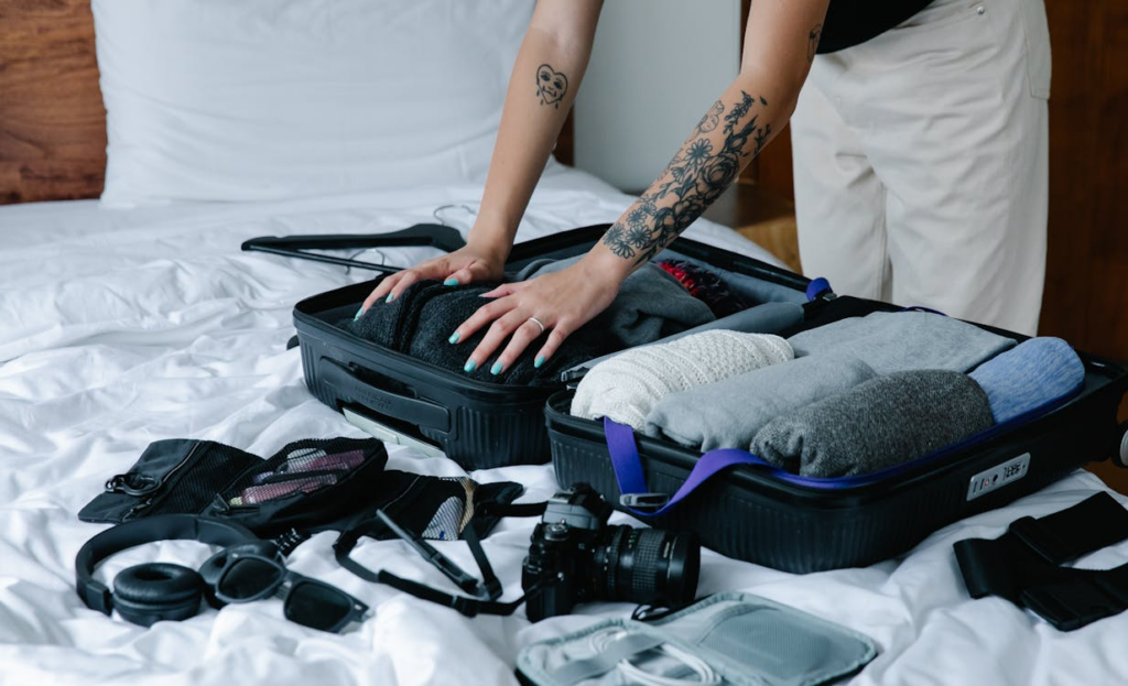 Traveler packing clothes for different climates without overpacking.