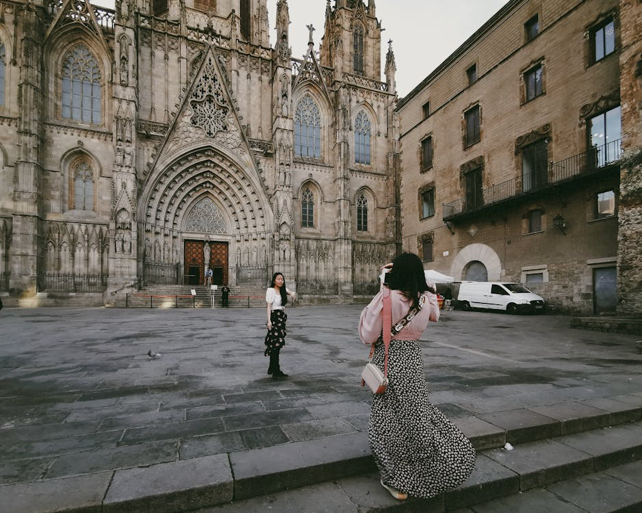 Traveler standing near Gothic architecture in one of the best cities for architecture lovers.