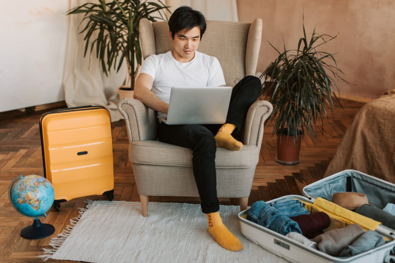 Traveler researching how far in advance to book hotels while packing for a trip.