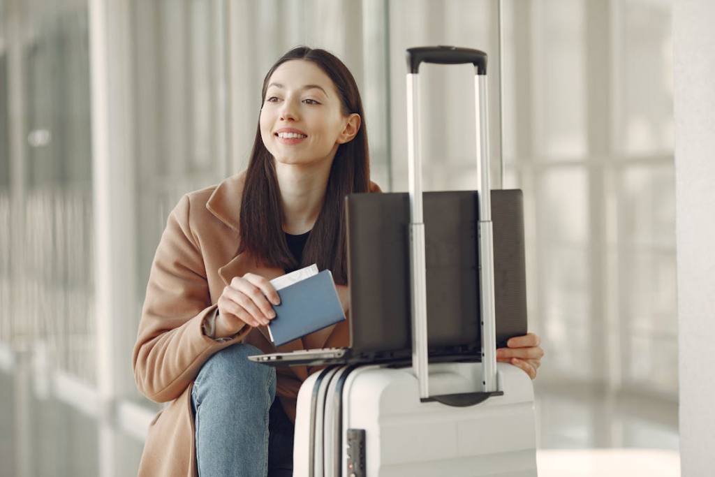 Traveler preparing for international travel for beginners with a passport and suitcase.